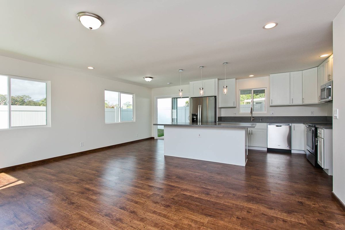 Dark wood-look vinyl plank running through an open-plan Wahiawa home